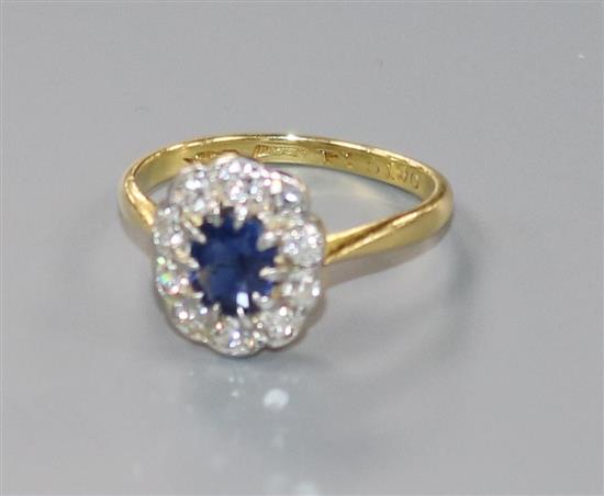 A mid 20th century 18ct gold and platinum, sapphire and diamond oval cluster ring, size M.